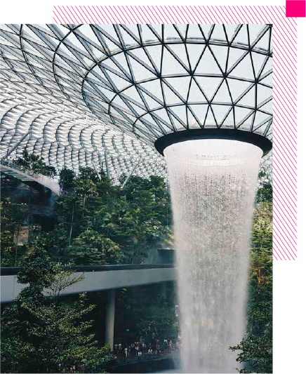 Photo of a property with a natural landscape, above a magenta box with the text: A property cannot be truly sustainable if it is not accessible Mahesh Ramanujam Former President & CEO USGBC